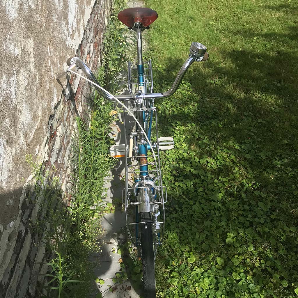 An image showing an old Batavus bicycle from 1968 restored to its original beauty and leaning against a wall
